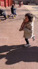 Children play outdoors with tricycles and hopscotch in France