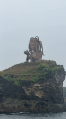 Weathered statue observed on cliff overlooking ocean in Nusa Penida