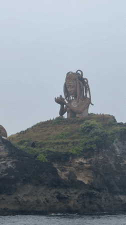 Weathered statue observed on cliff overlooking ocean in Nusa Penida