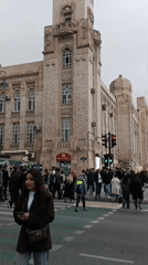 Pedestrians cross street during green light in Baku