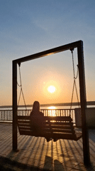 Woman enjoys quiet sunset moments by lake in Chaikovsky