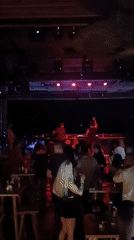Late-night venue buzzing under red and purple stage lights