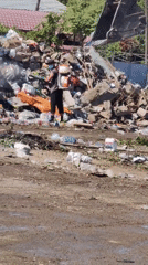 Heavy machinery clears debris at a Shymkent landfill site