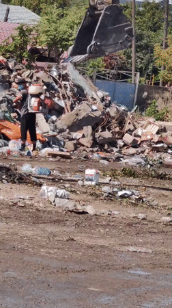 Heavy machinery clears debris at a Shymkent landfill site