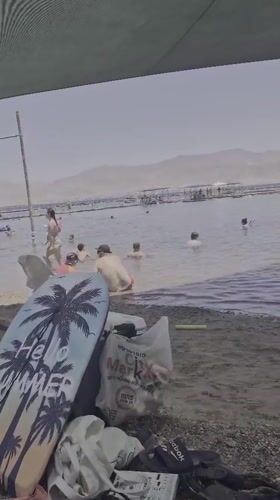 Beachgoers enjoy swimming activities in Eilat waters