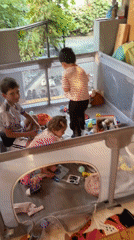 Kids playing in a playpen at a decorated outdoor gathering