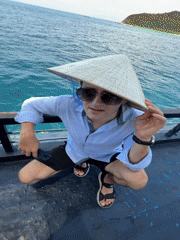 Tourist in conical hat photographed on boat near Nha Trang