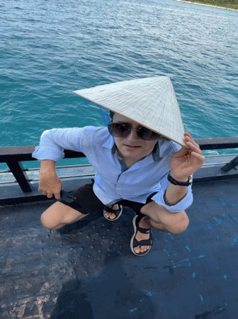 Tourist in conical hat photographed on boat near Nha Trang