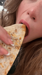 Woman enjoys quesadilla in Puebla, Mexico
