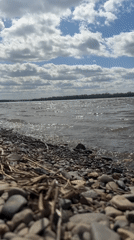 Early morning lakeside scenes include construction, luxury car, choppy waters