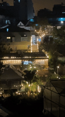Green-lit statue illuminates Đà Lạt hillside residential area