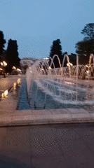 Evening fountain operation captured in public square