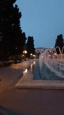 Evening fountain operation captured in public square