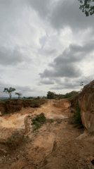 Red vehicle spotted on hilltop dirt road in Ezi