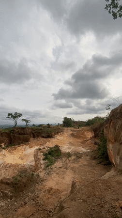 Red vehicle spotted on hilltop dirt road in Ezi