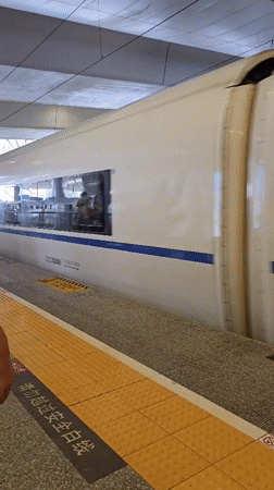 On board a bullet train, rolling through city and countryside