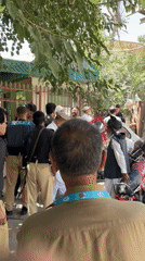 Police gather outside fenced building in Quetta, Pakistan
