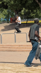 Scooter riders perform tricks at Barcelona urban park