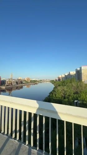Cyclist crosses bridge in Tyumen during early morning hours