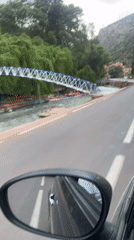 Vehicle drives through Tazitount, Morocco during overcast weather