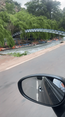 Vehicle drives through Tazitount, Morocco during overcast weather