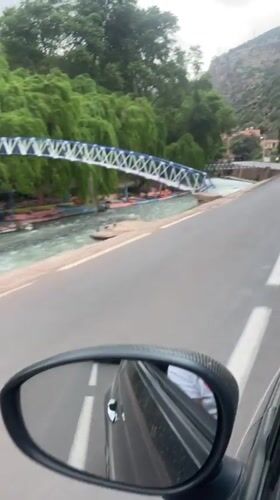 Vehicle drives through Tazitount, Morocco during overcast weather