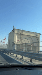 Car crosses bridge in Novocheboksarsk under clear skies