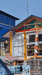 Morning street life beside an active renovation site in Lhokseumawe