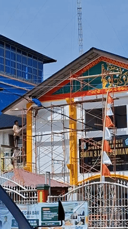 Morning street life beside an active renovation site in Lhokseumawe