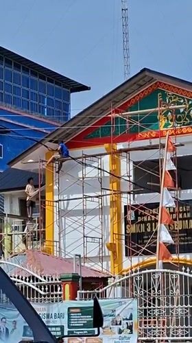 Morning street life beside an active renovation site in Lhokseumawe
