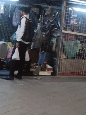 Nighttime outdoor market bustling with shoppers in Dubai