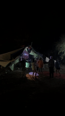 Night dancing outside a glowing striped tent in Cetinje