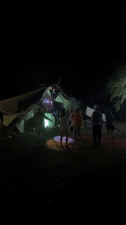 Night dancing outside a glowing striped tent in Cetinje
