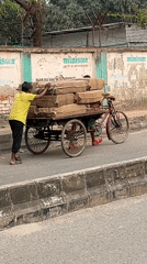 Daily street life unfolds in Dhaka neighborhood