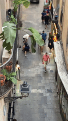 Altercation in a Barcelona cobblestone alley, white truck nearby