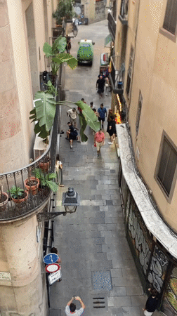 Altercation in a Barcelona cobblestone alley, white truck nearby