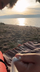 Lakeside beach hangout with picnic gear and calm water views