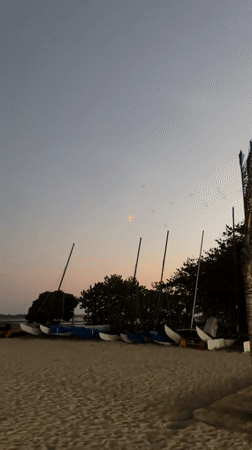 Live music and fireworks at a Bali beach event at dusk