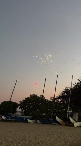 Live music and fireworks at a Bali beach event at dusk