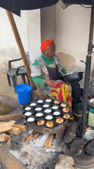 Morning street life in Jos, Nigeria, with a roadside incident nearby