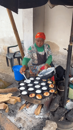 Morning street life in Jos, Nigeria, with a roadside incident nearby