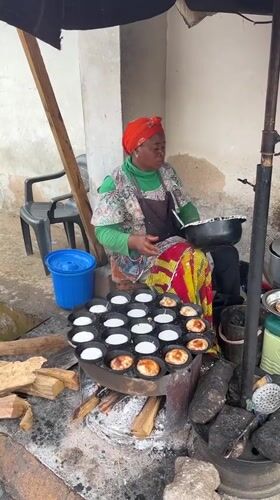 Morning street life in Jos, Nigeria, with a roadside incident nearby