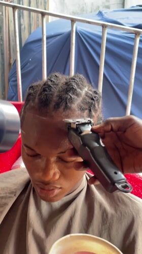 Onitsha barbershop serves customers during afternoon hours