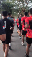 Group workout session on a paved outdoor path in Indonesia