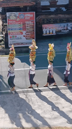 Traditional ceremonial procession winds through North Kuta streets