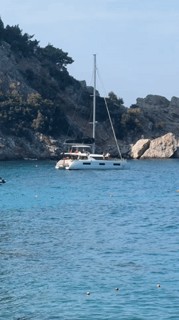 Fethiye bay buzzing with boats, swimmers, and paragliders