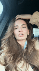Woman in trench coat observed in car passenger seat, Moscow