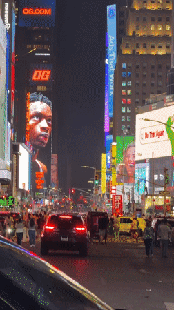 Times Square digital billboard displays 'OG' message at night
