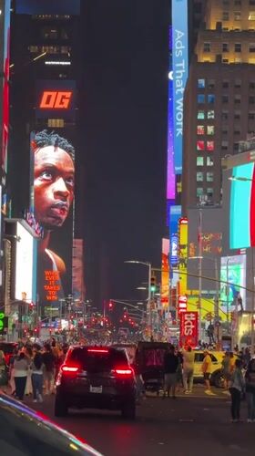 Times Square digital billboard displays 'OG' message at night