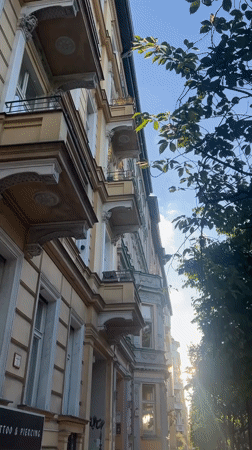 Berlin street lined with old apartments and a Negroni bar
